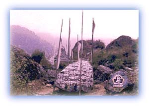 Prayer flags and stones marked with the Tibetan mantra Om mani padme hum -- mani stones. Credit: Scott Yost